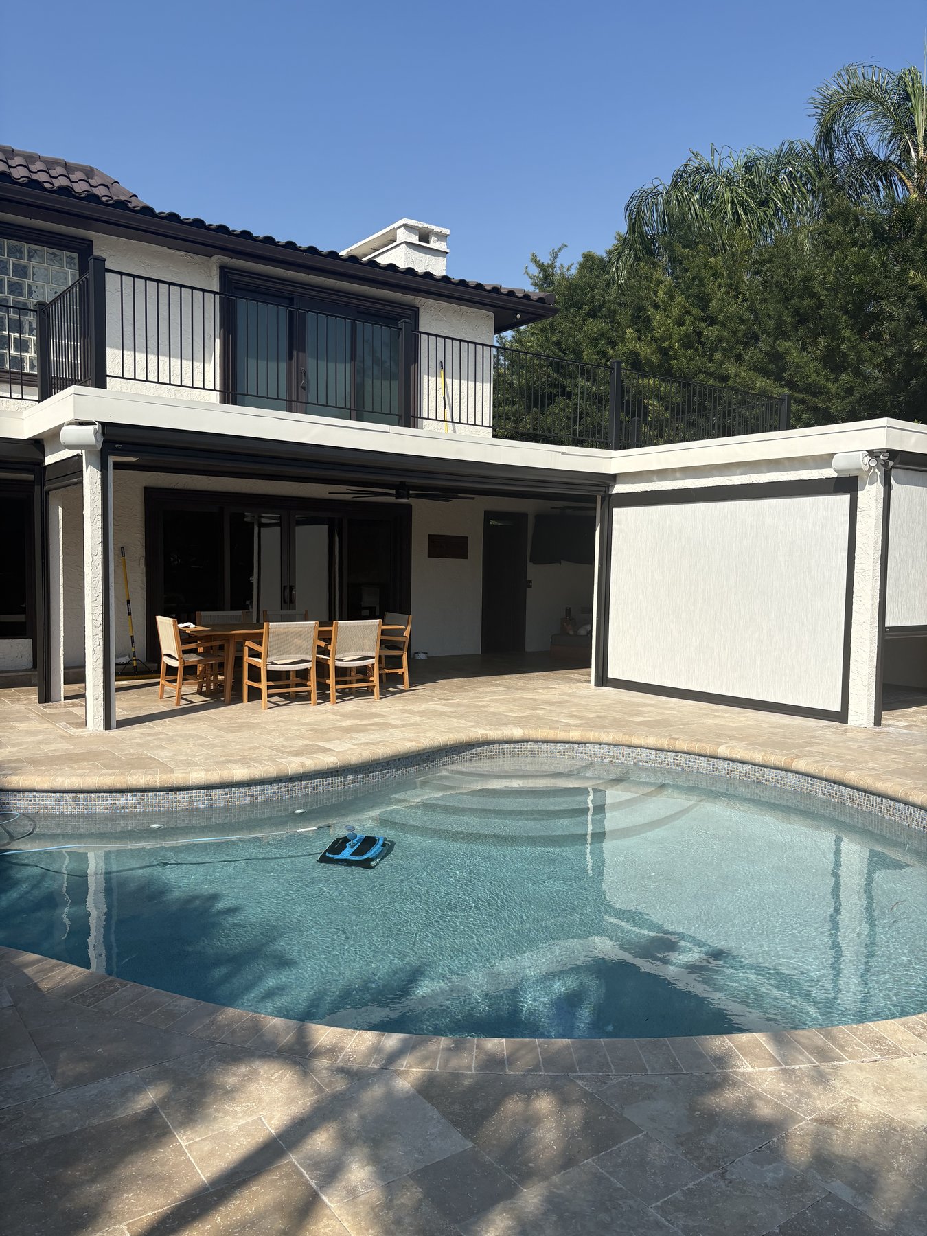 Pool and covered lanai with motorized screens at a Tampa Bay home