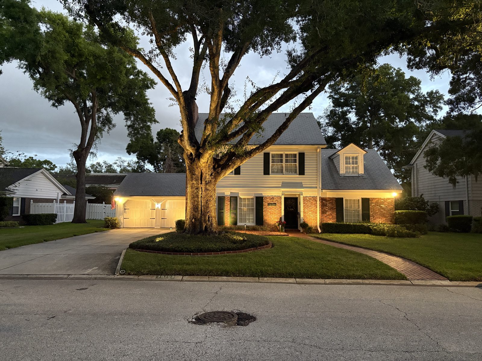 Front yard with mature oak tree at dusk in Tampa, FL