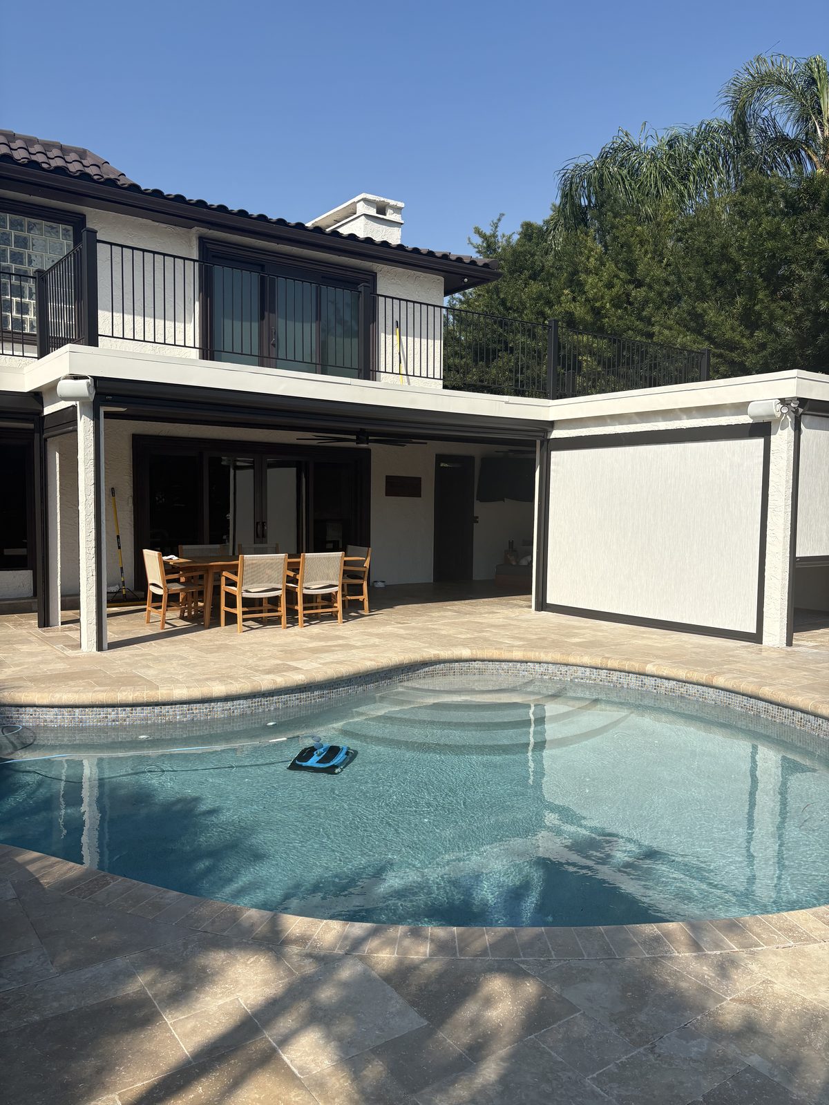 Pool lanai with outdoor dining and motorized shades in Tampa