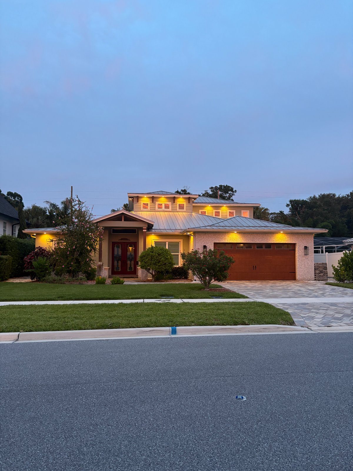 Coastal Tampa home at dusk with soffit lights across the eaves and garage, a real LogiBuilt install